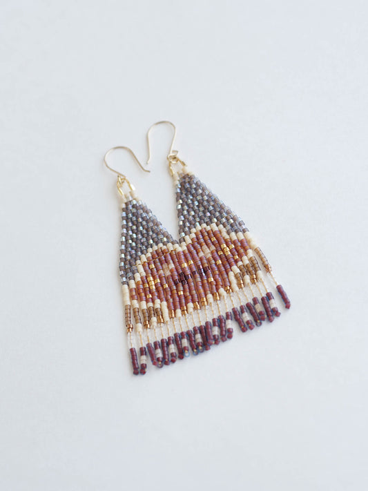 Beaded earrings with a geometric pattern on a light gray background